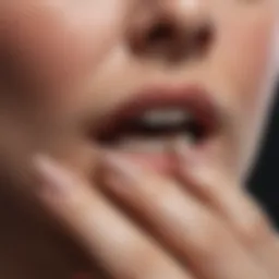 Close-up of a person's brittle nails highlighting their texture.