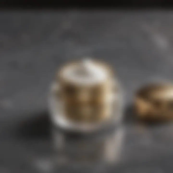 Close-up of a luxurious eye cream jar with a golden lid on a marble surface