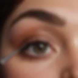 Essential tools for eyebrow shaping including tweezers and pencils