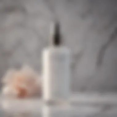 Luxurious White Elixir Elegant white setting spray bottle isolated on marble background