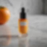 Close-up view of Herbivore Vitamin C Serum bottle on a marble countertop