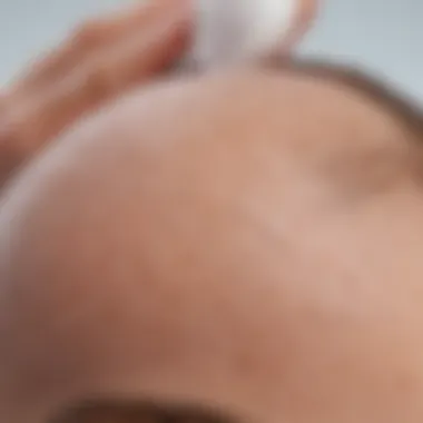 Close-up of the lightweight texture of Supergoop scalp sunscreen being applied to the scalp.